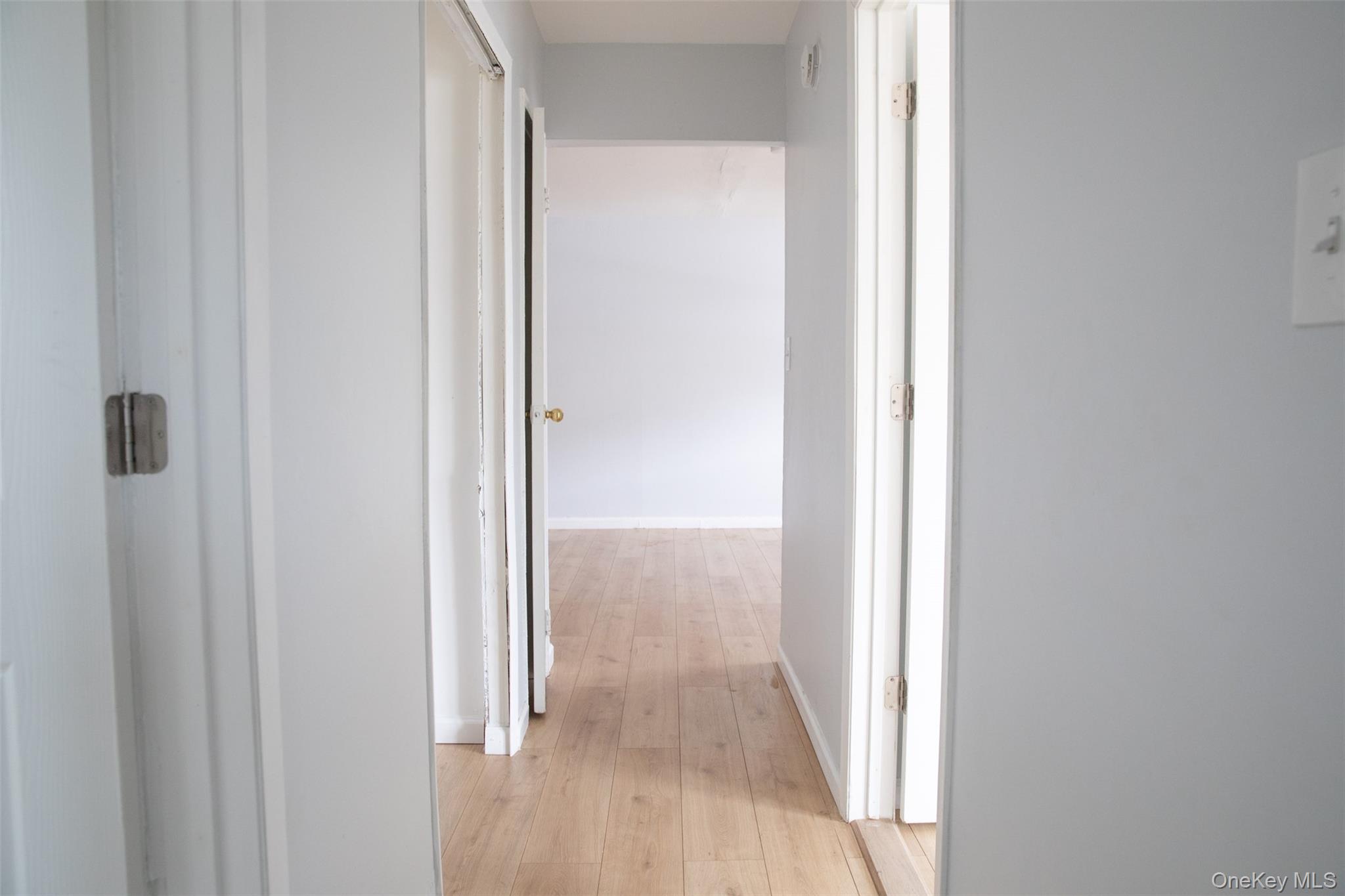 1 A Jamestown Court Ridge, NY 11961 - Photo 8 of 15 a view of a bathroom from a hallway