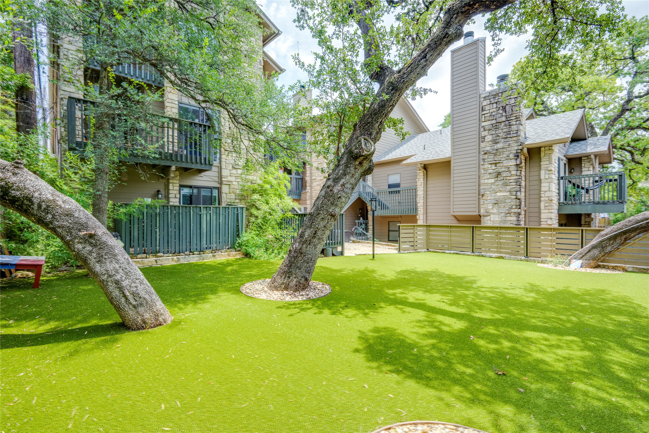 3627 Menchaca Road, Unit 214 Austin, TX 78704 - Photo 22 of 28 Manicured green spaces define this charming multi-level residence with private balconies.