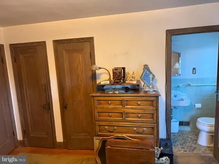 a bathroom with a sink toilet and window
