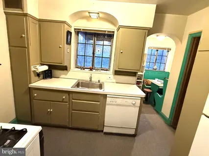 a bathroom with a sink a mirror and shower