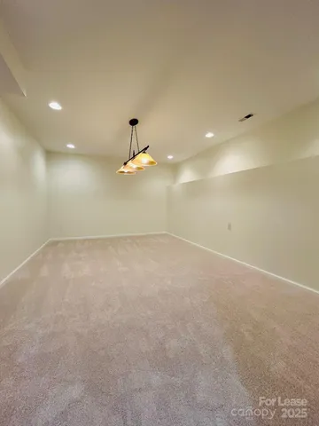 an empty room with a ceiling fan and window