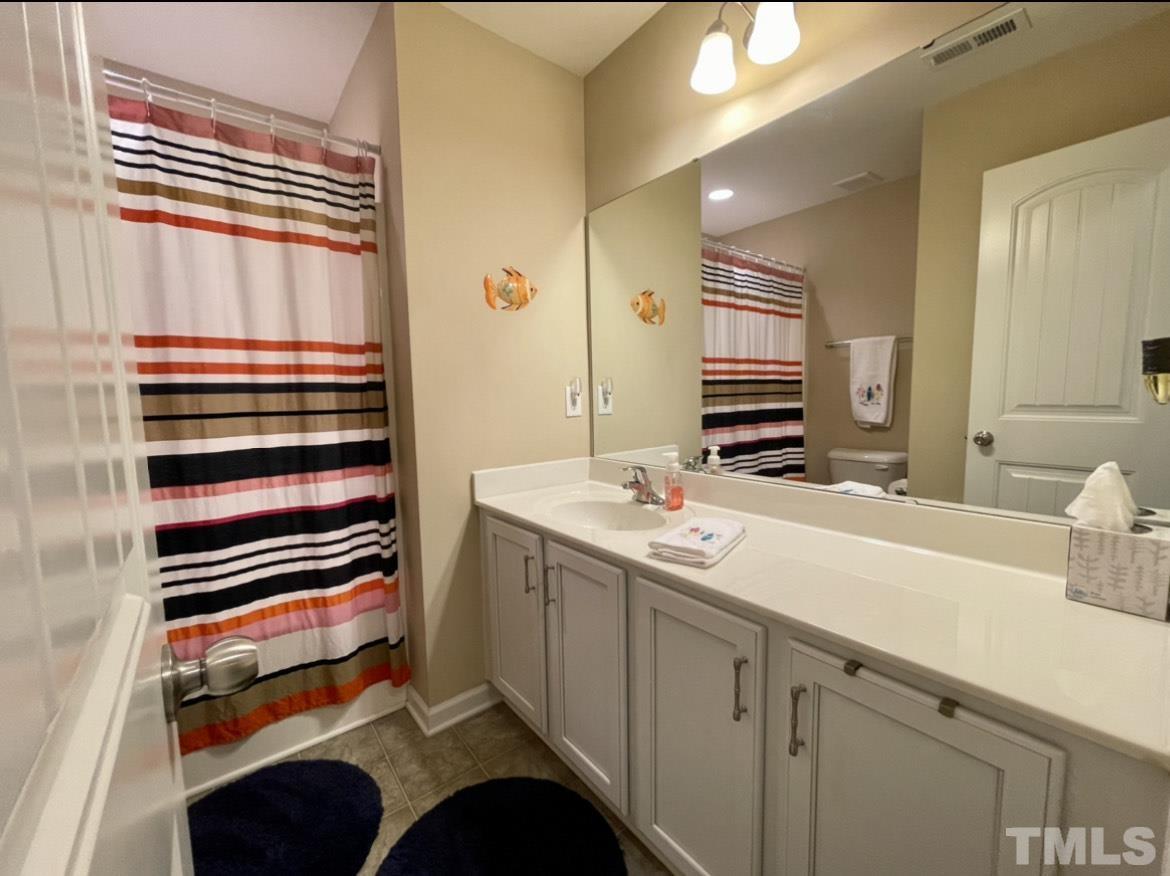 306 Leighann Ridge Lane Rolesville, NC 27571 - Photo 11 of 13 a bathroom with a sink and a mirror