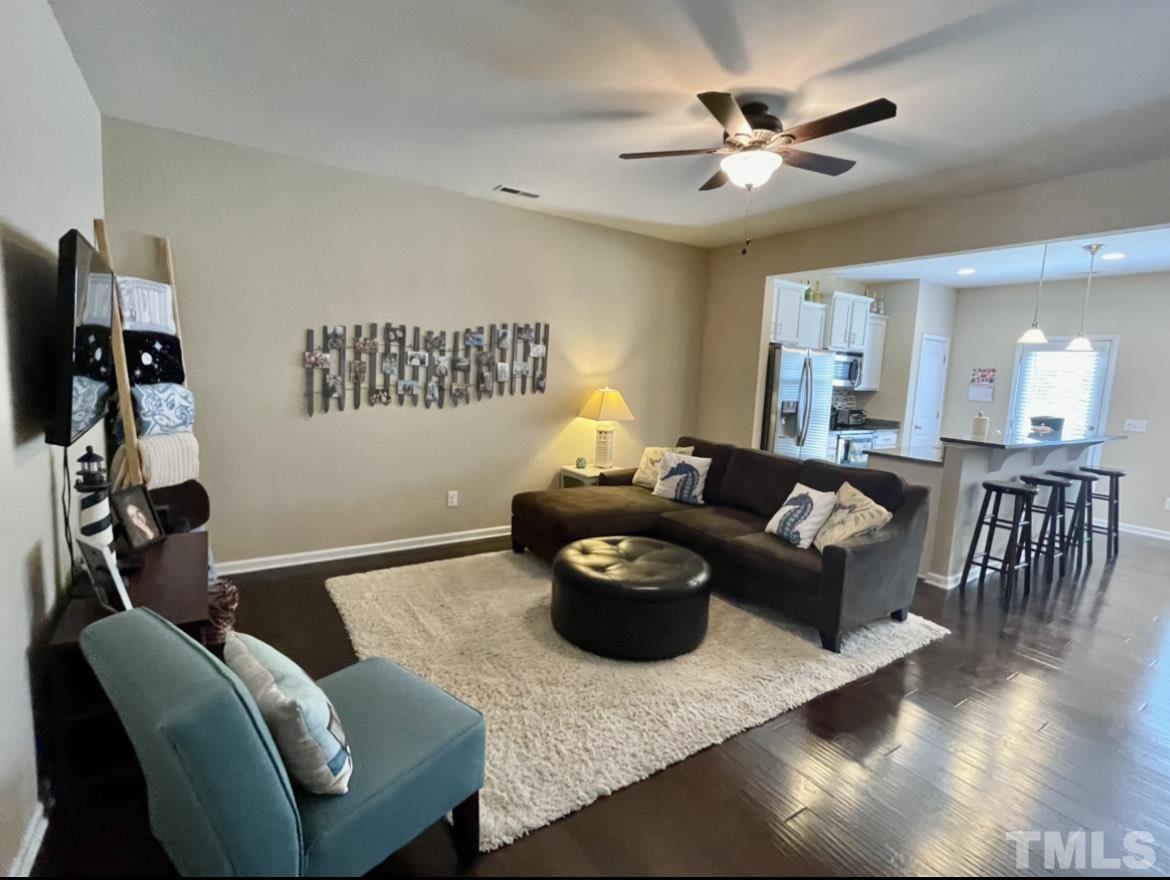 306 Leighann Ridge Lane Rolesville, NC 27571 - Photo 4 of 13 a living room with furniture and a chandelier