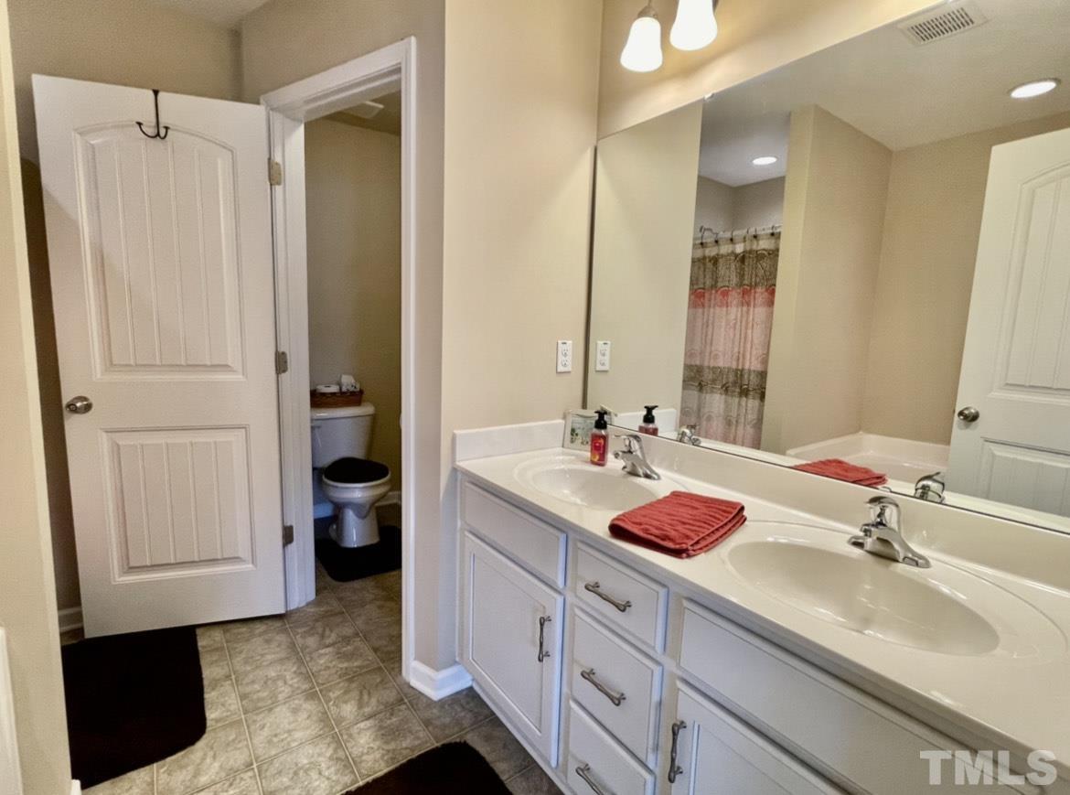 306 Leighann Ridge Lane Rolesville, NC 27571 - Photo 8 of 13 a bathroom with a sink and a mirror