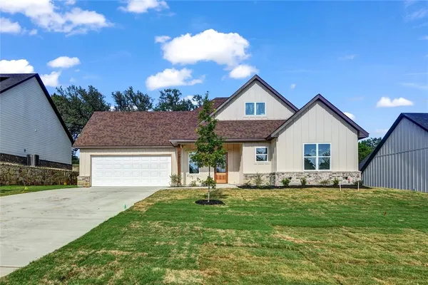 a front view of house with yard and green space