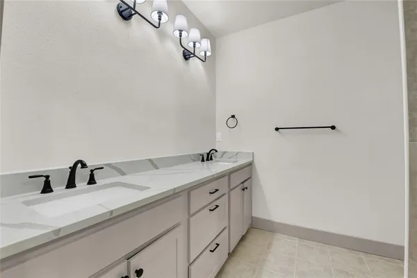 a bathroom with a double vanity sink and mirror