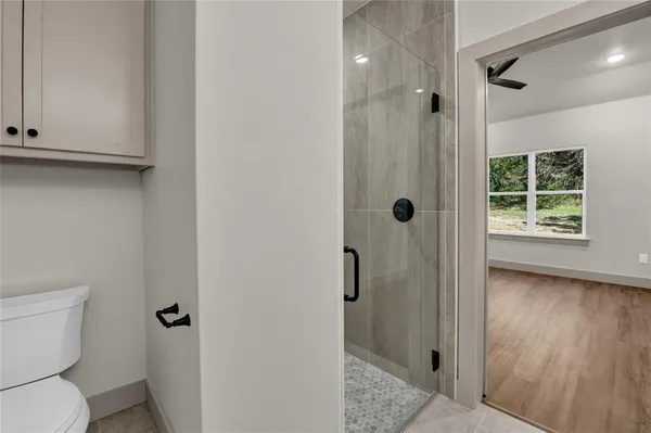 a bathroom with a shower a toilet and a sink