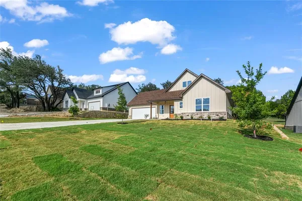 a front view of house with yard and green space