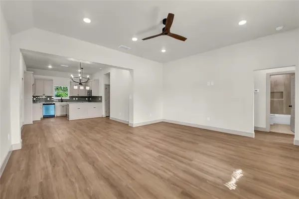 a view of a kitchen with a sink and stainless steel appliances