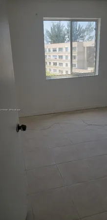 a view of an empty room with a window