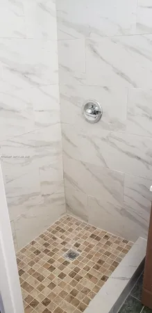 a bathroom with a granite countertop shower