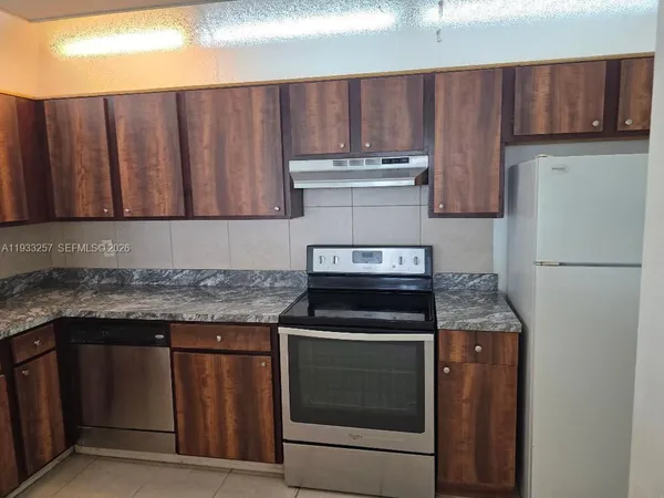 a kitchen with stainless steel appliances granite countertop a stove and a refrigerator