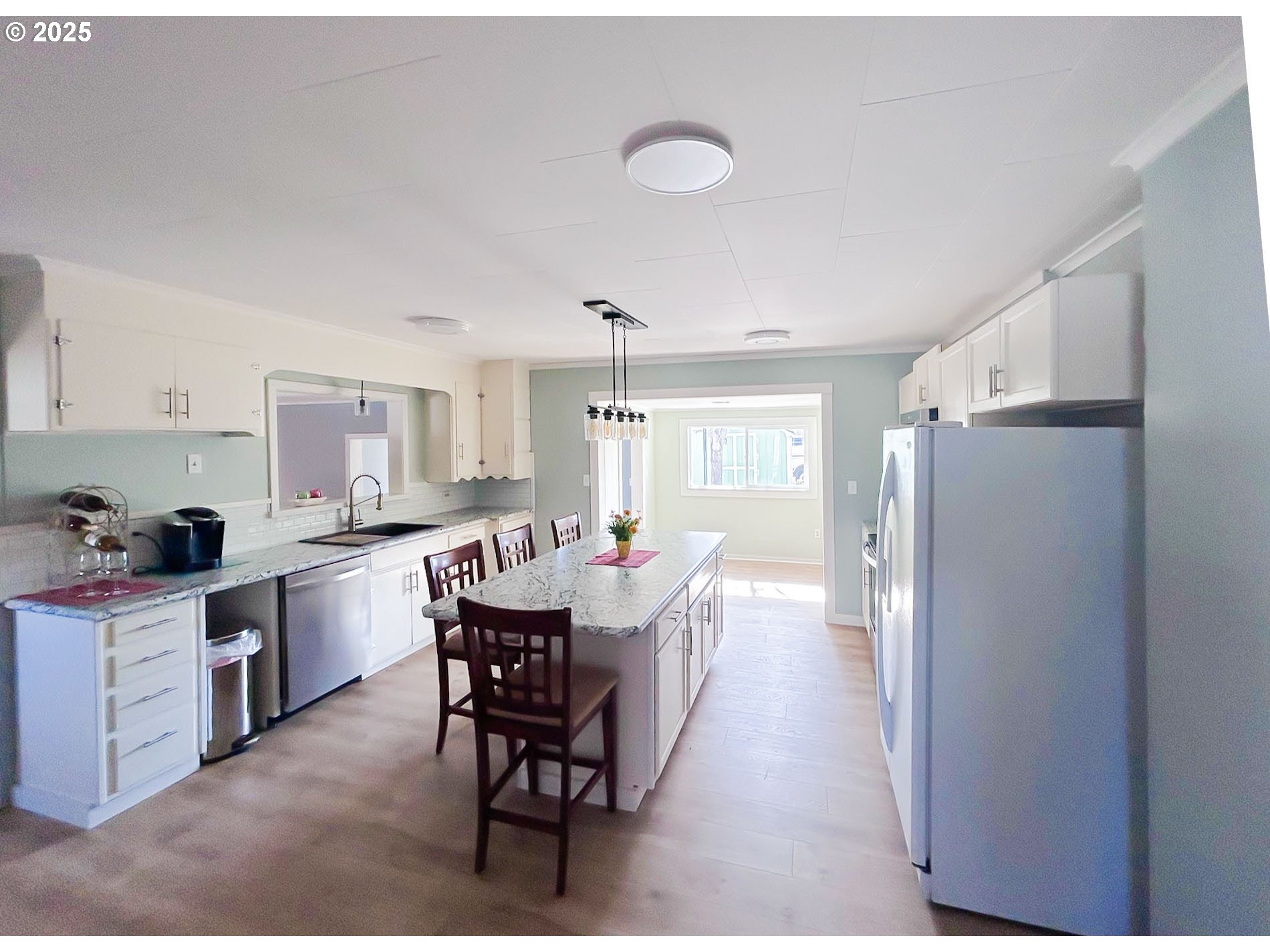 1925 Myrtle Street Baker City, OR 97814 - Photo 26 of 31 a kitchen with stainless steel appliances granite countertop a refrigerator a sink dishwasher a dining table and chairs with wooden floor