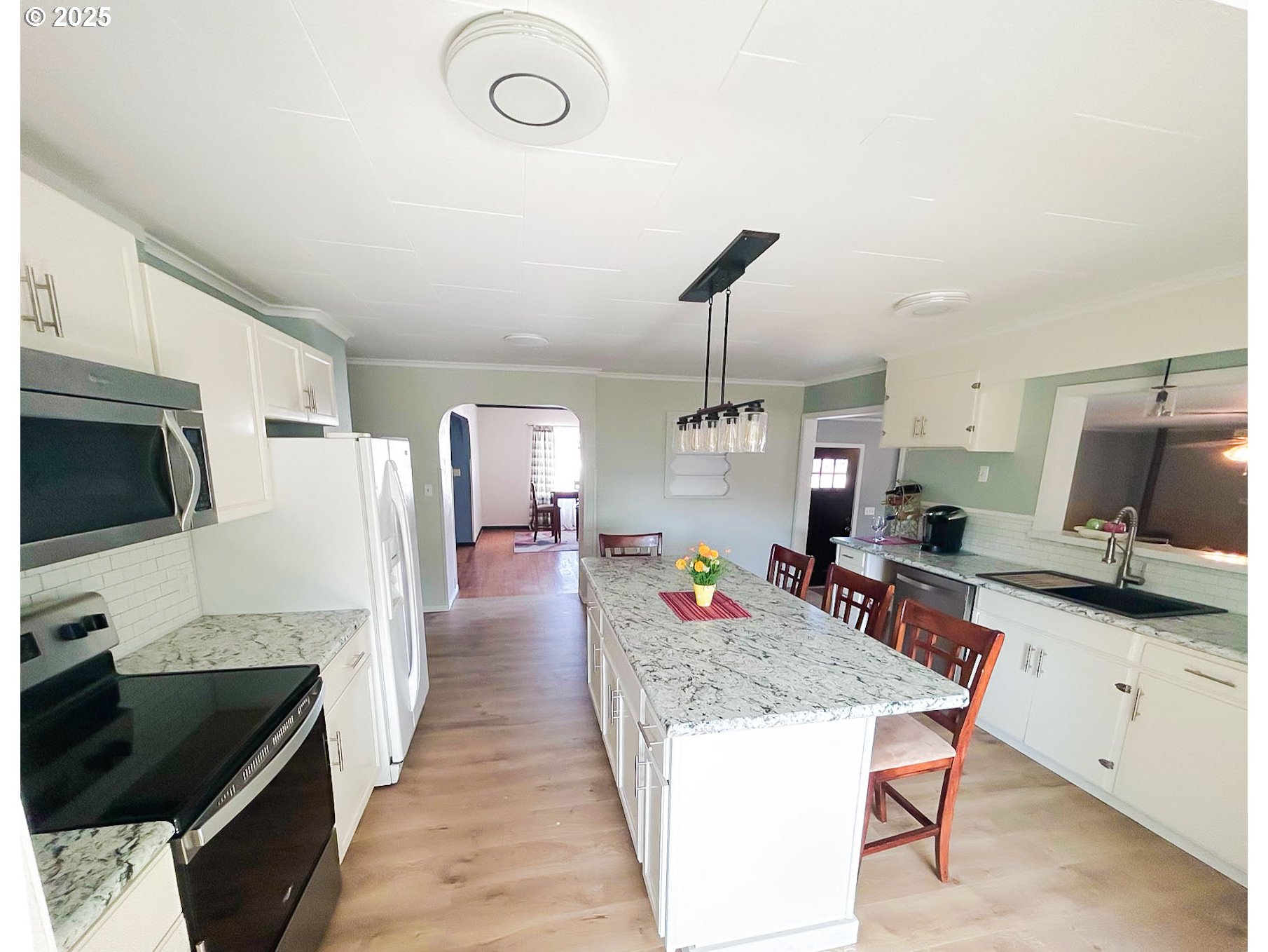 1925 Myrtle Street Baker City, OR 97814 - Photo 28 of 31 a kitchen with stainless steel appliances kitchen island granite countertop a sink a stove and a refrigerator