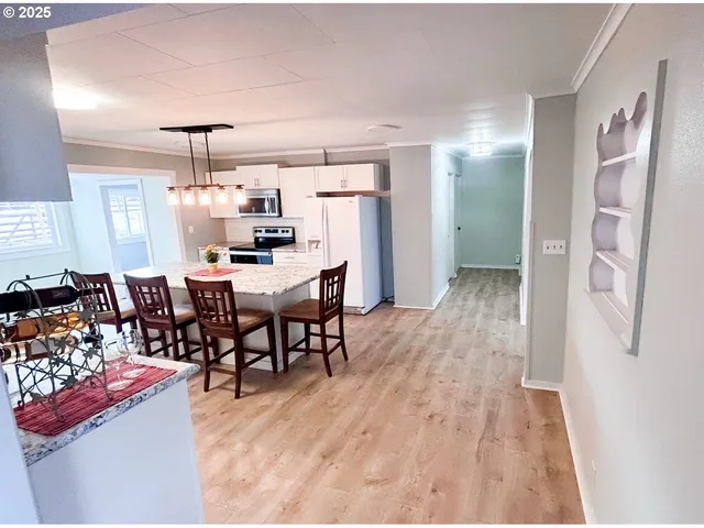 a dining room with furniture and wooden floor