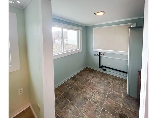 a room with window and a bathroom with sink