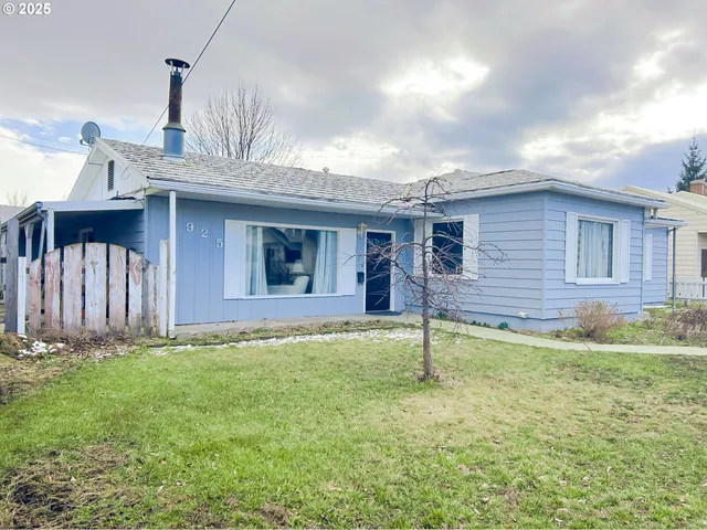 a view of a livingroom with wooden floor and a window