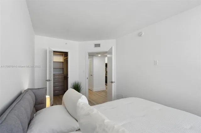 a bedroom with a bed and a couch