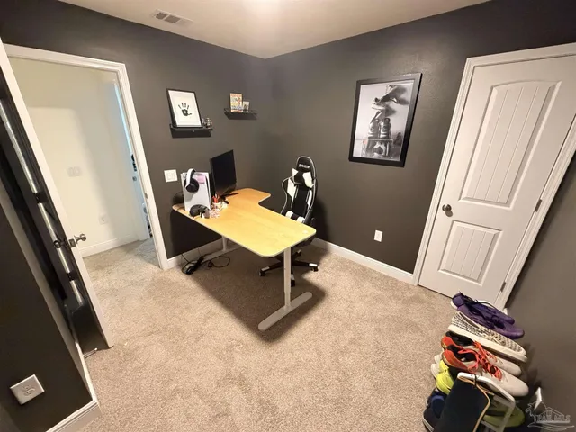 a living room with a furniture and a flat screen tv