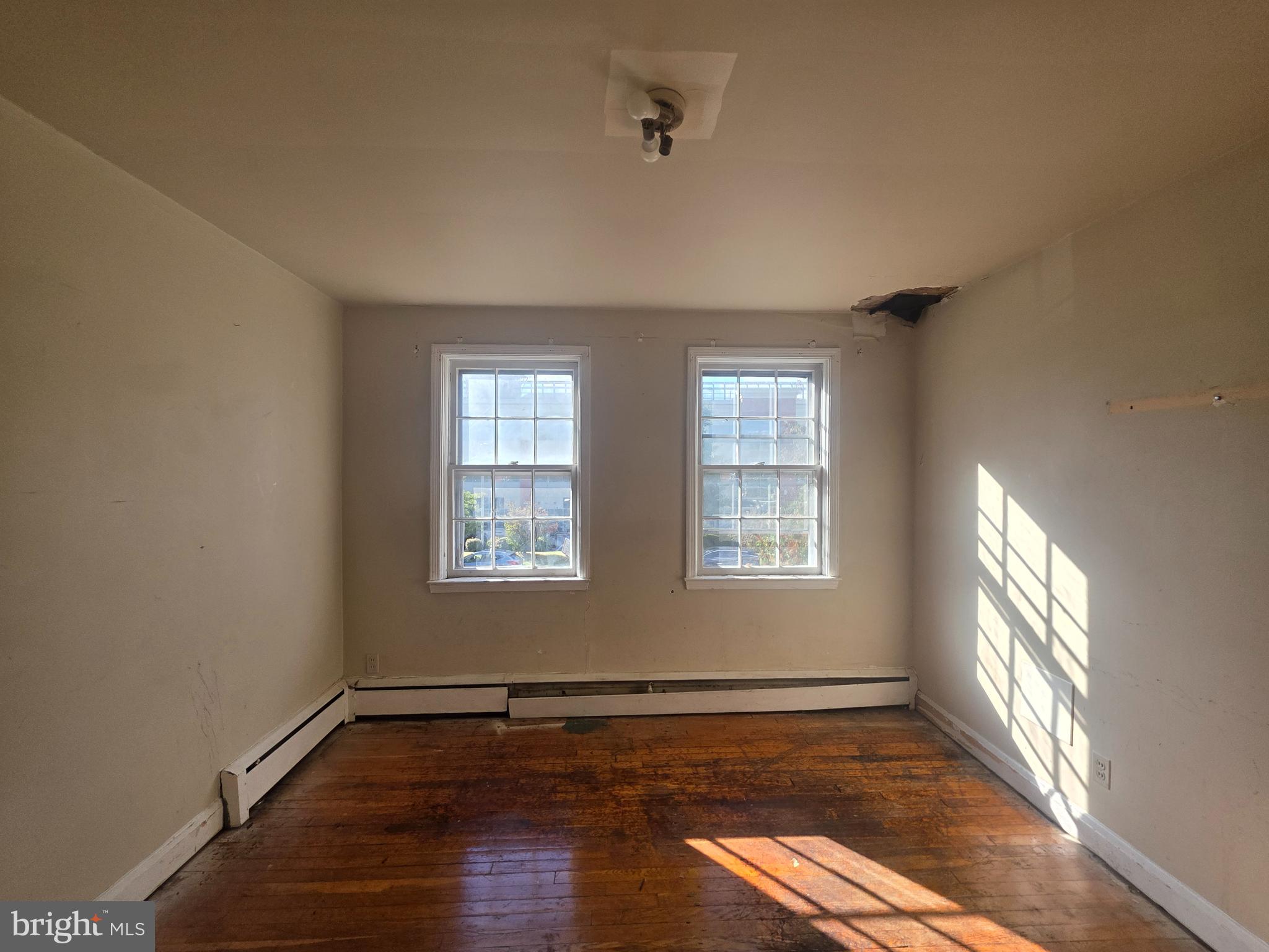 5933 Leith Walk Baltimore, MD 21239 - Photo 15 of 28 a view of an empty room with wooden floor and a window