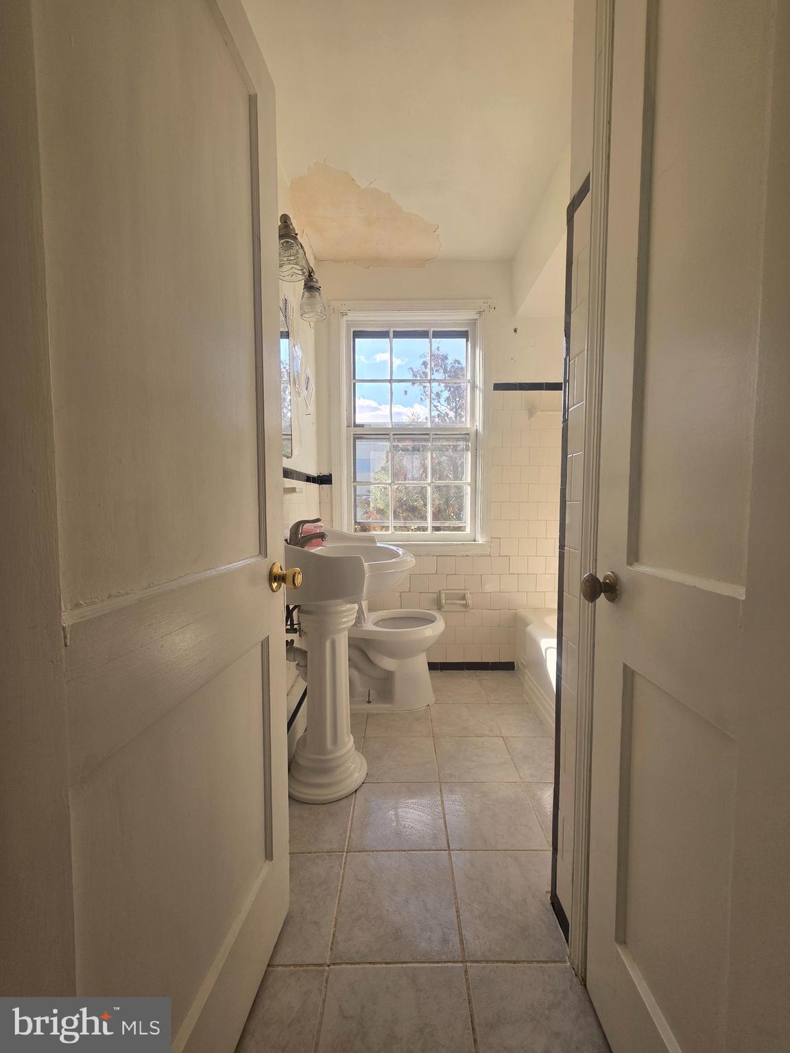 5933 Leith Walk Baltimore, MD 21239 - Photo 19 of 28 a bathroom with a toilet and a shower