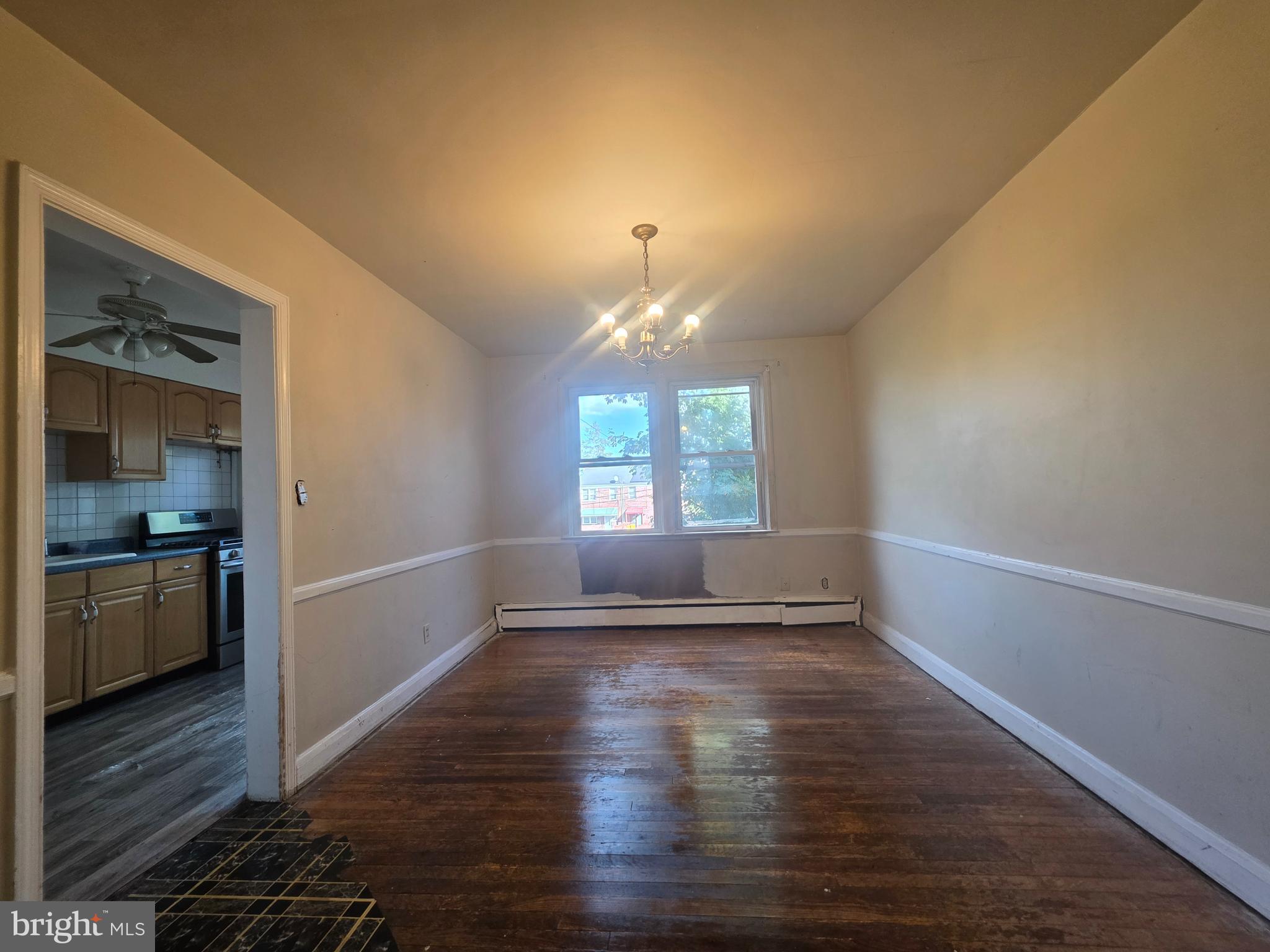 5933 Leith Walk Baltimore, MD 21239 - Photo 5 of 28 a view of empty room with wooden floor and fan