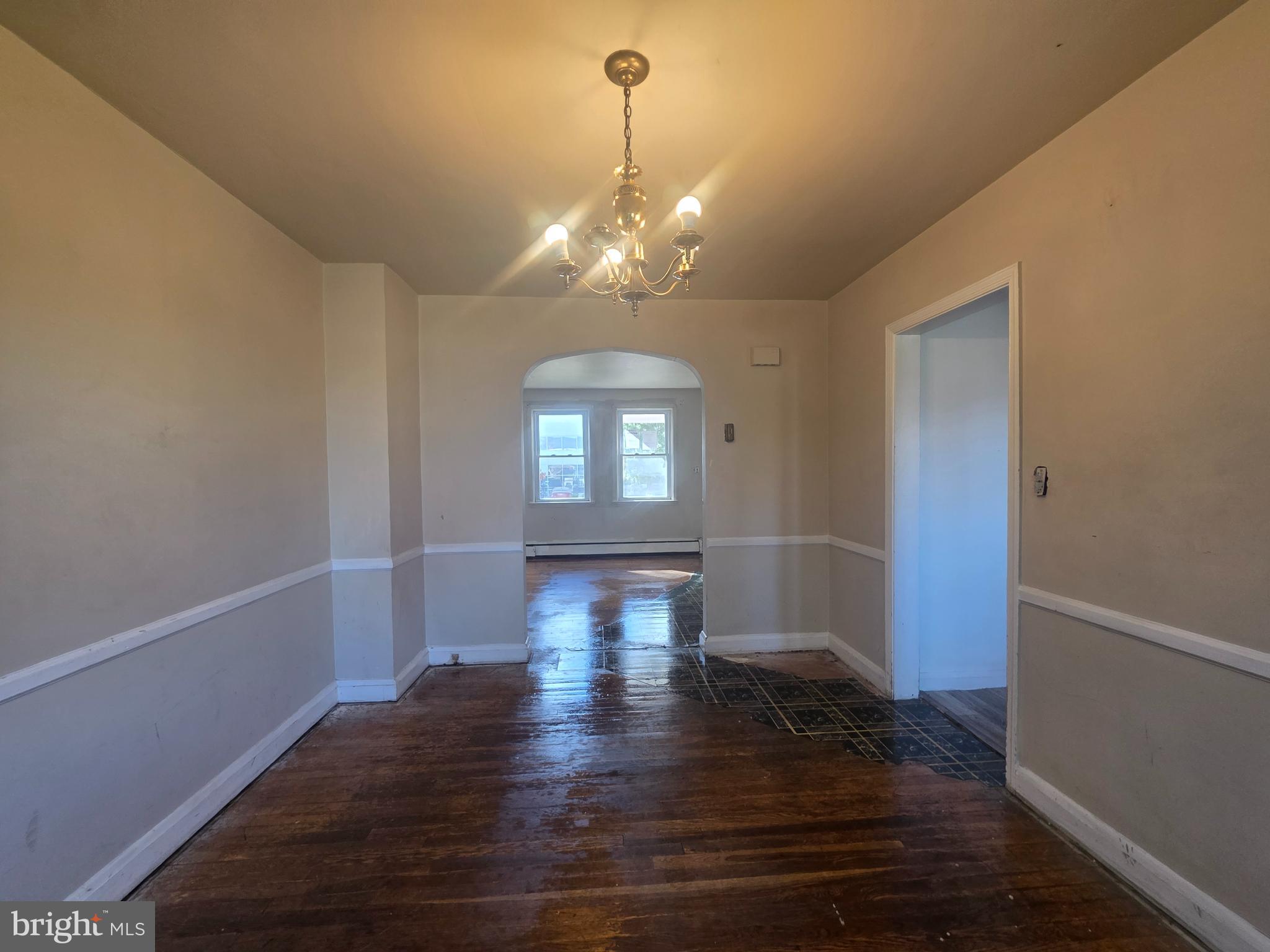 5933 Leith Walk Baltimore, MD 21239 - Photo 6 of 28 a view of empty room with wooden floor and fan