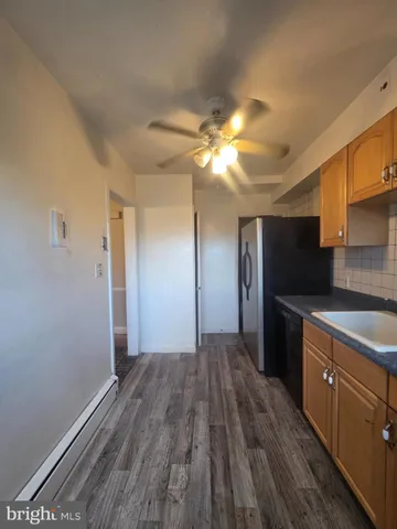 a kitchen with a refrigerator and a sink