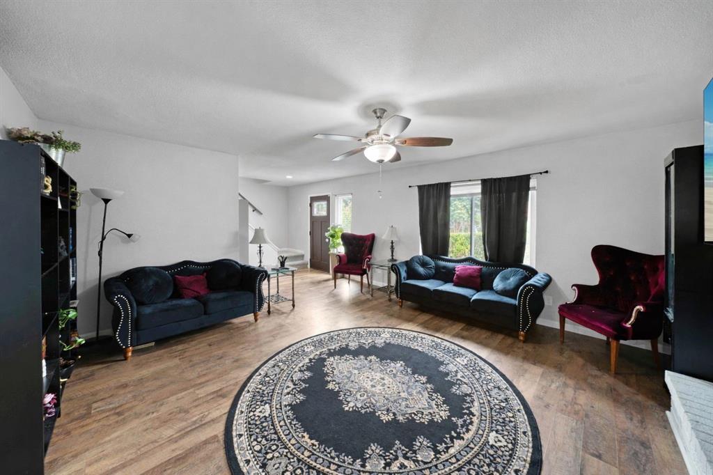 1301 Thoreau Lane Allen, TX 75002 - Photo 11 of 31 a living room with furniture and a chandelier