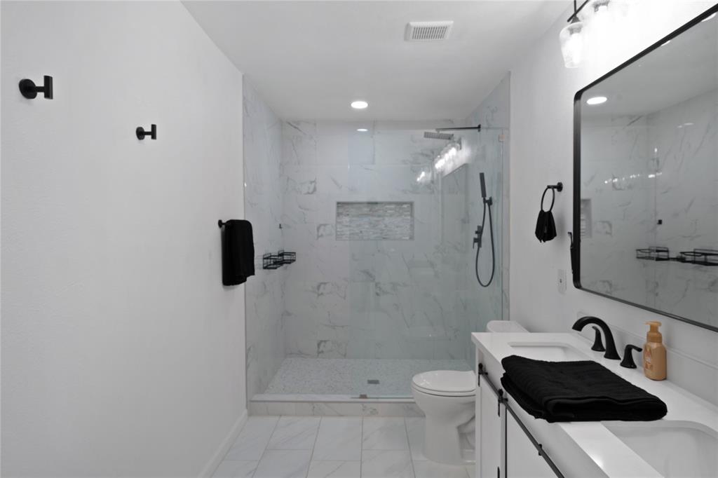 1301 Thoreau Lane Allen, TX 75002 - Photo 14 of 31 a bathroom with a sink a toilet and shower