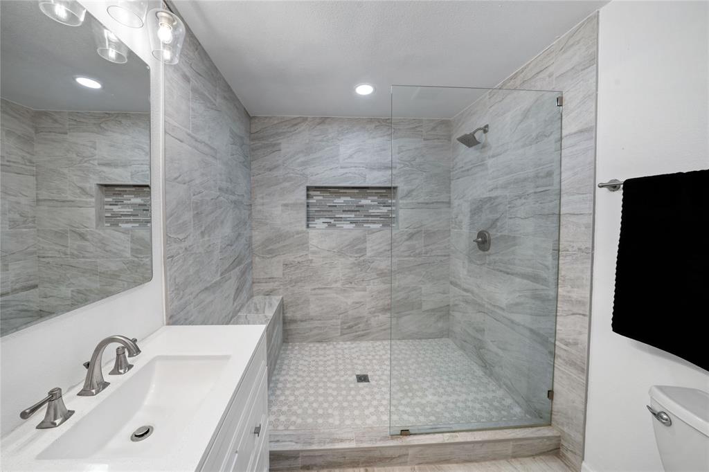 1301 Thoreau Lane Allen, TX 75002 - Photo 16 of 31 a bathroom with a shower sink and mirror