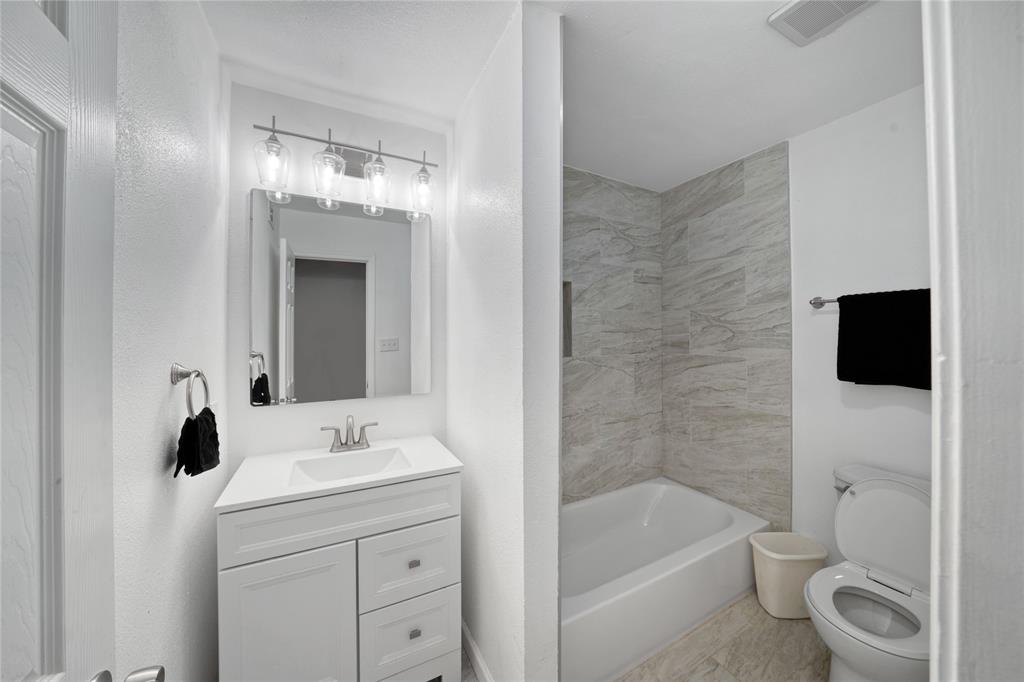 1301 Thoreau Lane Allen, TX 75002 - Photo 17 of 31 a bathroom with a sink a toilet and shower