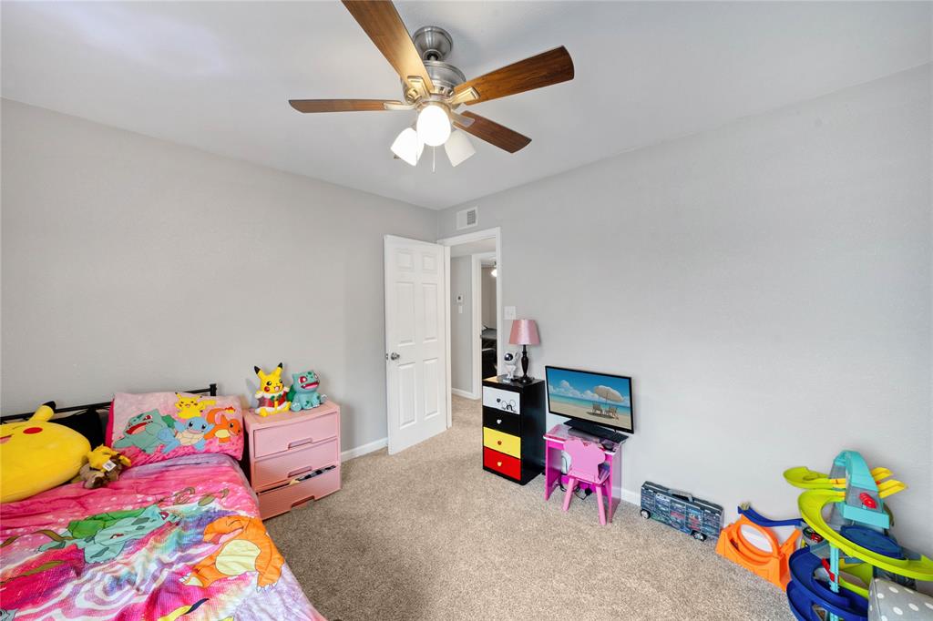 1301 Thoreau Lane Allen, TX 75002 - Photo 18 of 31 a bedroom with a bed and a couch