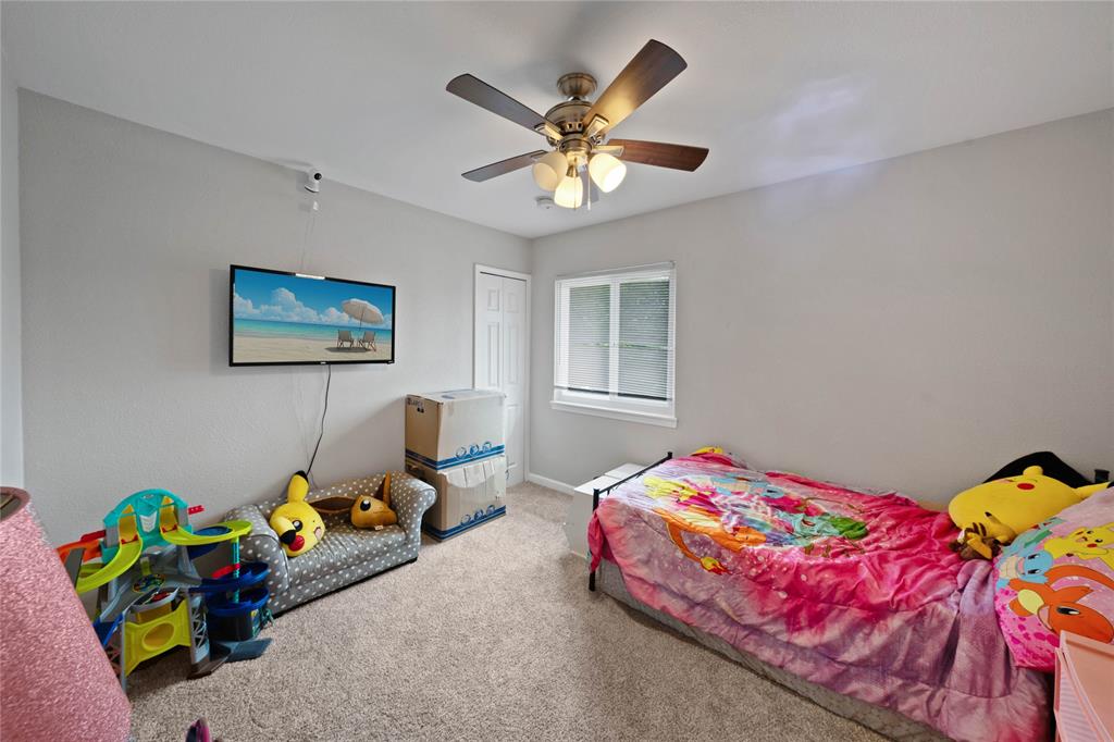 1301 Thoreau Lane Allen, TX 75002 - Photo 19 of 31 a bedroom with a bed and a chandelier