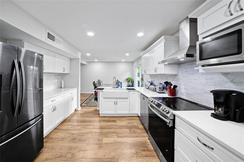 1301 Thoreau Lane Allen, TX 75002 - Photo 5 of 31 a large kitchen with stainless steel appliances kitchen island a stove and a sink