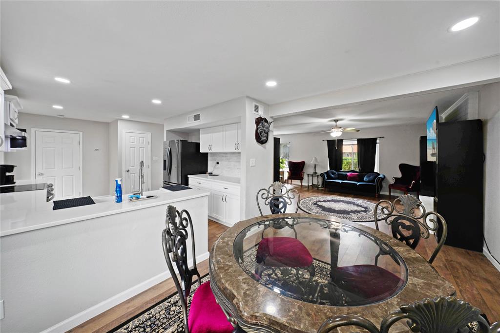 1301 Thoreau Lane Allen, TX 75002 - Photo 9 of 31 a kitchen with stainless steel appliances kitchen island granite countertop a sink a stove a refrigerator cabinets and living room view