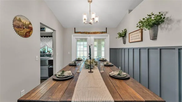 a view of a dining room with furniture and chandelier