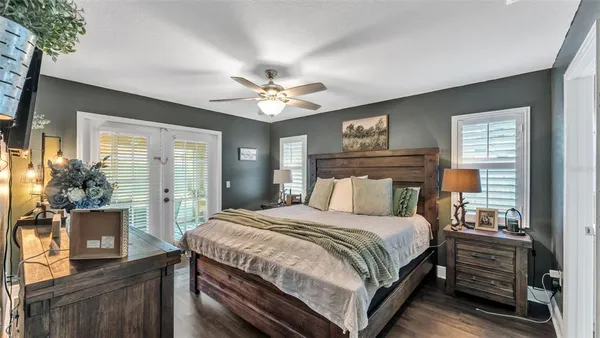 a bedroom with a bed and a chandelier
