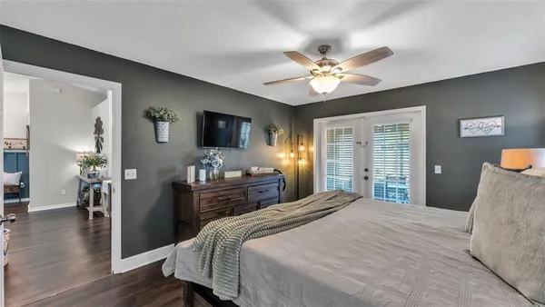 a bedroom with a bed and a chandelier