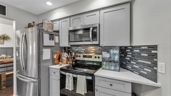 a kitchen with a refrigerator stove and microwave
