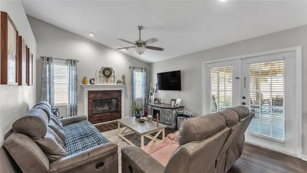 a living room with furniture fireplace and a flat screen tv