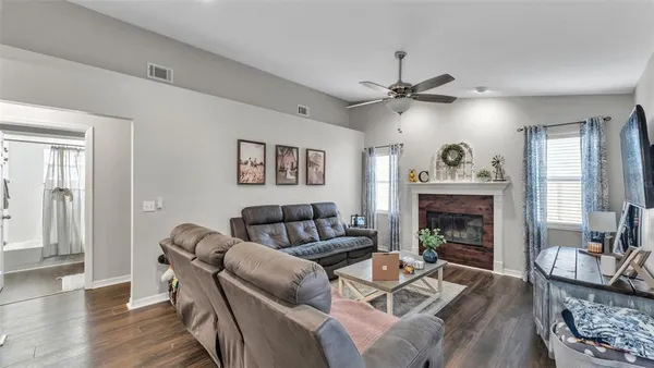 a living room with furniture and a fireplace