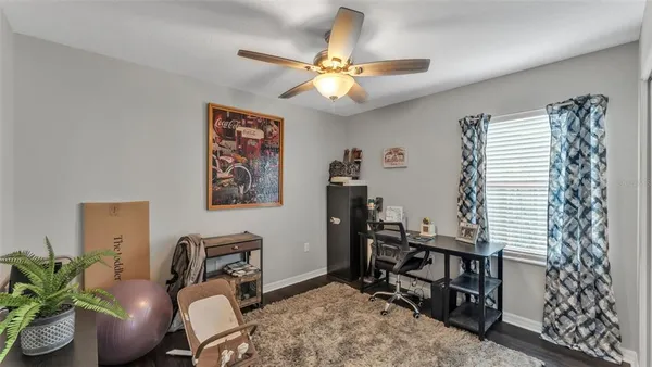 a view of a workspace with furniture and a window