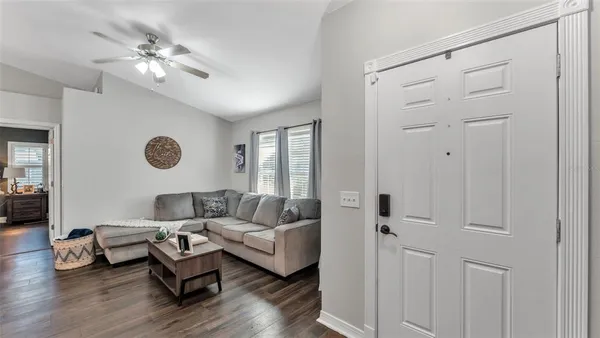a living room with furniture and a chandelier