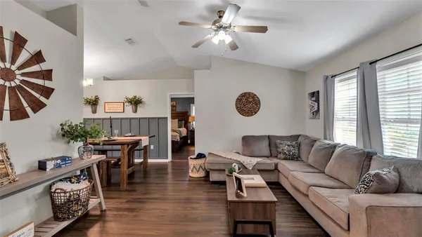 a living room with furniture and wooden floor