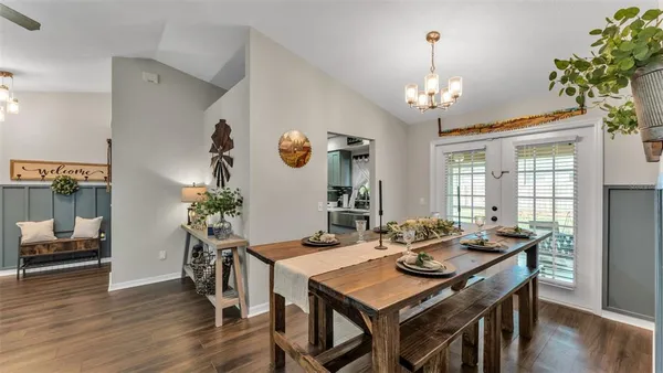 a view of a dining room with furniture wooden floor and chandelier