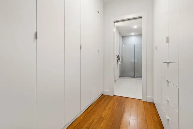 a view of a hallway with wooden floor