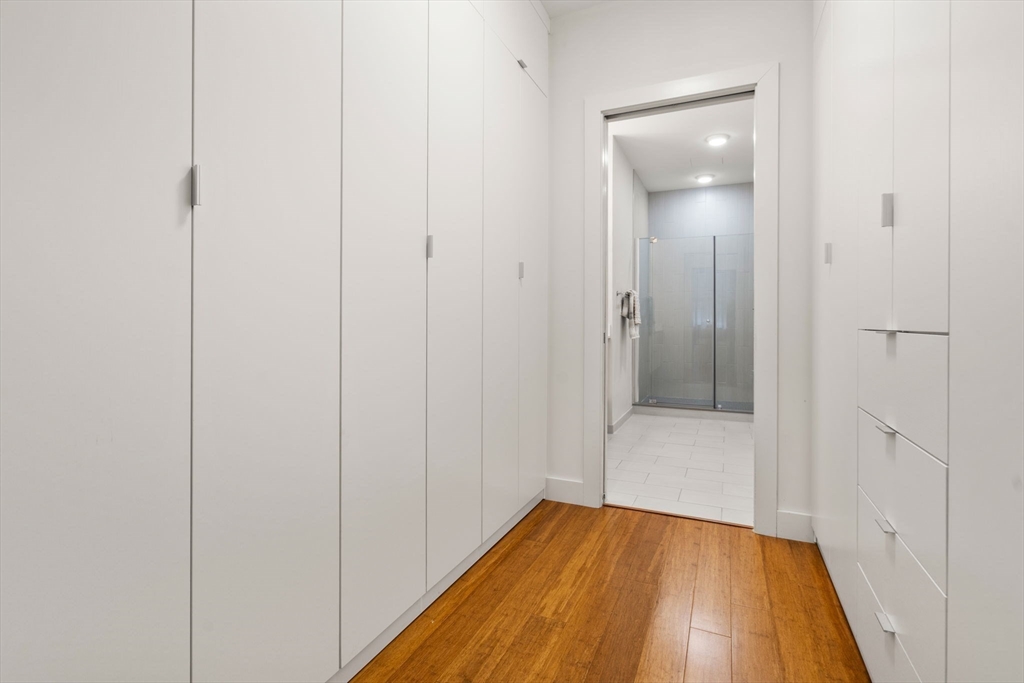 121-127 Portland Street, Unit 202 Boston, MA 02114 - Photo 14 of 25 a view of a hallway with wooden floor