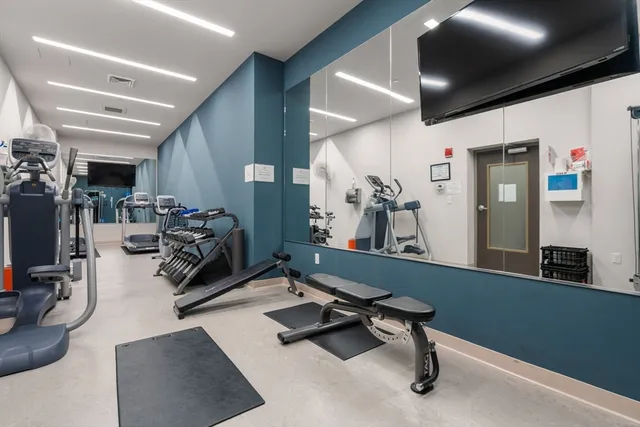 a room with gym equipment and a large window