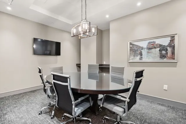 a view of a dining room with furniture and a chandelier